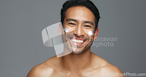 Image of Face, cream and man with skincare, glow and dermatology with grooming, wellness and shine on grey studio background. Portrait, person or model with creme, beauty or cosmetics treatment with aesthetic