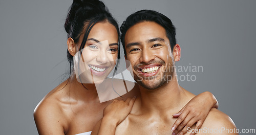 Image of Couple, smile and care for skincare, happy and portrait for wellness in studio by gray background. Happy people, dermatology and hug for cosmetics, hydration and glow or love for skin treatment