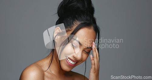 Image of Face touch, skincare and smile of woman in studio isolated on gray background. Portrait, natural beauty and hand of model in spa facial treatment for aesthetic, glow and cosmetic wellness for health