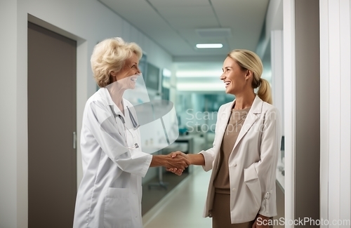 Image of A compassionate doctor shares a handshake with her patient, signifying a successful and trustful completion of hospital treatment