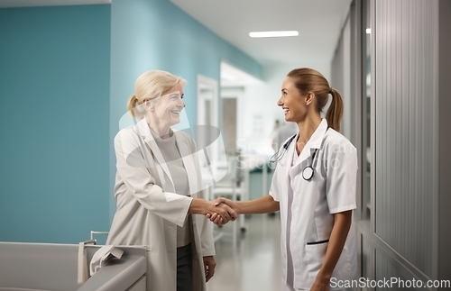 Image of A compassionate doctor shares a handshake with her patient, signifying a successful and trustful completion of hospital treatment