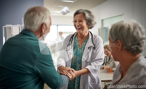 Image of A compassionate female doctor shares a handshake with an elderly man, symbolizing gratitude and successful completion of hospital treatment