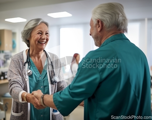 Image of A compassionate female doctor shares a handshake with an elderly man, symbolizing gratitude and successful completion of hospital treatment