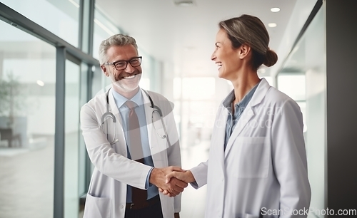 Image of In a modern hospital corridor, doctors exchange handshakes, reflecting professional unity and collaborative teamwork