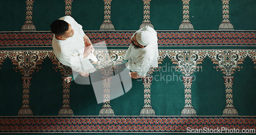 Image of Muslim, religion and top view of people in mosque for talking, conversation and greeting in community. Islamic worship, friends and above of men in religious building for Ramadan, prayer and praise