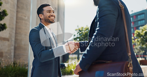 Image of City, business people and handshake with happy employees and smile from project deal and success. Conversation, teamwork and outdoor with staff and urban building with speaking and shaking hands