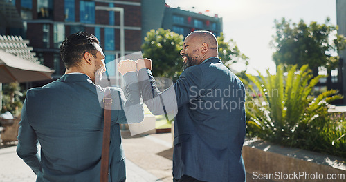 Image of Business people, fist bump and greeting outdoor, deal and thank you for partnership in the city. Back, happy team and hand gesture for agreement, collaboration and men walking together in urban town