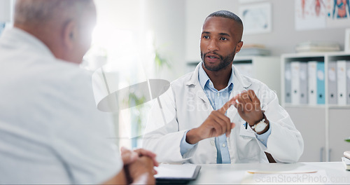 Image of Doctor, patient and consultation with conversation for healthcare, people in office with advice or instructions for medication. Treatment, medical info and elderly care with communication at clinic