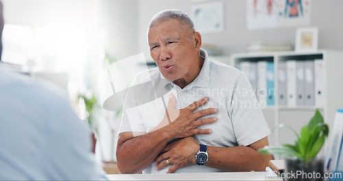 Image of Senior, man and consulting doctor on chest pain, sore or discomfort in healthcare hospital. Mature, male person or patient talking to medical employee for heart ache, breathing or illness at clinic