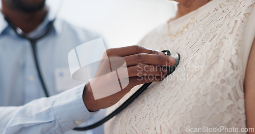 Image of Hand, chest and stethoscope, doctor and patient for healthcare, cardiology and listening to heart at clinic. Medical exam for diagnosis, monitor heartbeat and people in consultation with health