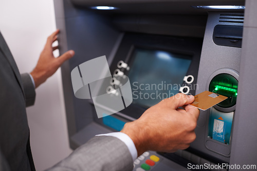 Image of Businessman, hands and credit card at ATM machine for banking, cash withdrawal or money transfer on account. Closeup of man or investor inserting debit for fintech, interaction or electronic deposit