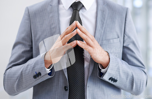 Image of Hands in front of chest, business and man with confidence, closeup and suspicious in workplace. Person, employee or consultant in suit, gesture or deception with fraud or idea with feedback or review