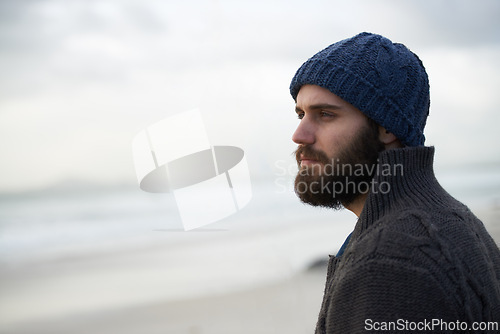 Image of Thinking, calm and man at beach with memory, nostalgia or reflection with ocean view in nature. Remember, travel and male person at sea for fresh air, journey or peaceful Florida vacation in winter