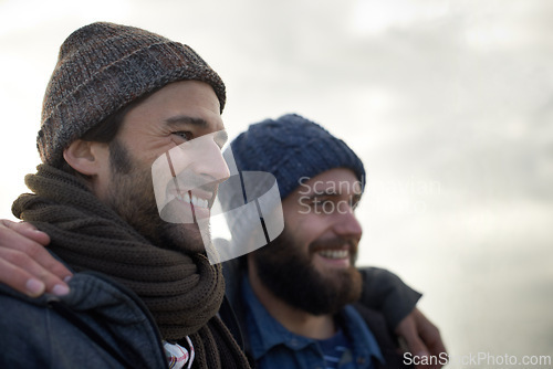 Image of Happy, men and friends hug at a beach for bonding, holiday and adventure in winter together. Travel, smile and people embrace in nature for ocean vacation, journey or fun journey in South Africa