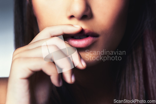 Image of Beauty, hand and closeup of woman lips in studio for facial makeup routine with gloss. Cosmetic, beautiful and zoom of female person touching mouth for cosmetology treatment by gray background.