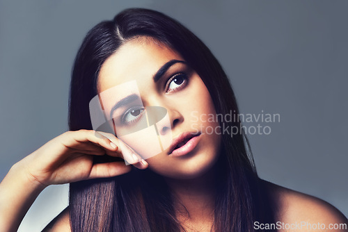 Image of Thinking, beauty and woman with makeup, cosmetics and ideas on a grey studio background. Person, wonder and model with dermatology and grooming with shine and glow with wellness, thought or self care