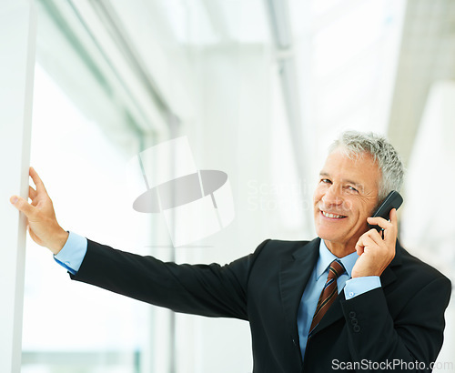 Image of Mature employee, smile and phone call in office building talking to boss of corporate company for business. Executive, chat and happy for job in workplace, technology and connect for communication