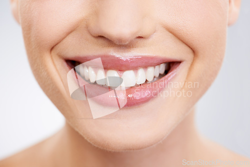 Image of Beauty, mouth and teeth with woman closeup in studio on gray background for dental care or oral hygiene. Skincare, smile and orthodontics with happy young model at spa or dentist for natural wellness