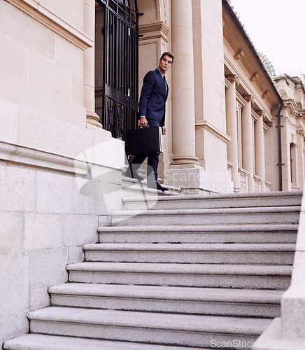 Image of Business, briefcase and man on stairs outside law firm in city with evening commute, checking sidewalk and court building. Businessman, lawyer or attorney on outdoor steps with bag for urban travel.