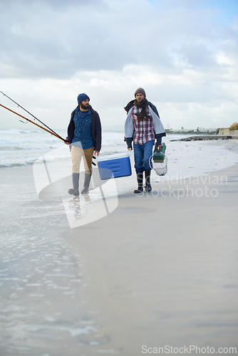 Image of Adventure, fishing and men walking on beach together with cooler, tackle box and holiday bonding. Ocean, fisherman and friends with rods, bait and tools at waves on winter morning vacation at sea.