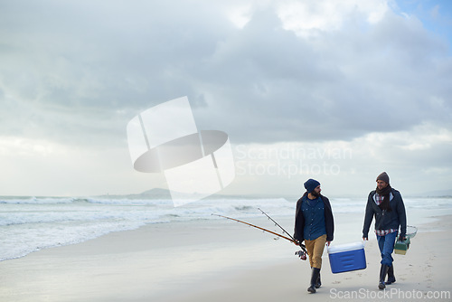 Image of Clouds, fishing and men walking at ocean together with cooler, tackle box and holiday in mockup space. Beach, fisherman and friends with rods, bait or tools at waves on winter morning vacation at sea