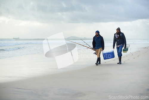 Image of Friends, fishing and men walking on beach together with cooler, tackle box and holiday mockup space. Ocean, fisherman and people with rods, bait and tools at waves on winter morning vacation at sea.