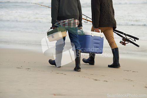 Image of Walk, fishing and men on beach together with cooler, tackle box and holiday adventure. Ocean, fisherman and friends with rods, bait and tools for hobby at waves on winter morning vacation at sea.