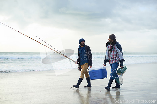 Image of Hobby, fishing and men walking on beach together with cooler, tackle box and holiday conversation. Ocean, fisherman and friends with rods, bait and tools at waves on winter morning vacation at sea.