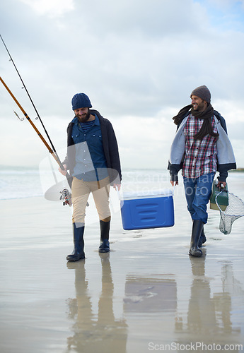 Image of Waves, fishing and men walking on beach together with cooler, tackle box and holiday conversation. Ocean, fisherman and friends with rods, bait and tools in nature on winter morning vacation at sea.