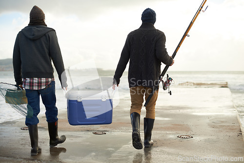 Image of Back, beach and fishing, men, cooler and early overcast morning with vacation and hobby. Rear view, people and friends with a cold box and rod with ocean and weekend break for activity and holiday