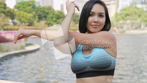 Image of Active Woman Stretching Arms in the Park
