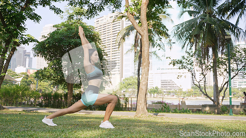 Image of Healthy Woman Exercising in Green City Park