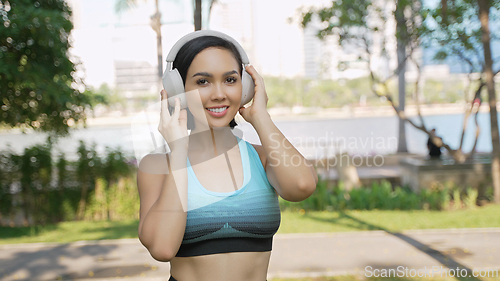 Image of Active Woman Enjoying Music During Park Workout