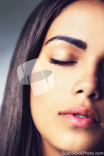 Image of Face, natural beauty and woman with eyes closed, calm for cosmetics and dermatology on grey background. Clean skin facial and wellness, young Brazilian model with skincare and antiaging in studio