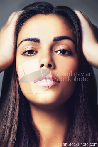 Image of Face, natural beauty and woman with hair, cosmetics treatment or keratin with clear skin on grey background. Portrait, skincare and dermatology, Brazilian model for haircare and wellness in studio