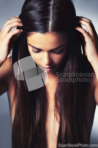 Image of Hair, beauty and woman with shine from cosmetics treatment or keratin for growth on grey background. Cosmetology, long and straight hairstyle with haircare, wellness and hairdresser in studio