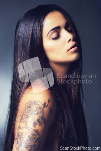 Image of Hair, beauty and woman with skin, cosmetics treatment or keratin for growth and tattoo on grey background. Dermatology, long and straight hairstyle with haircare, wellness and skincare in studio