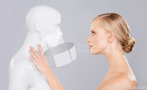 Image of Studio, woman and mannequin with perfect beauty versus fake standard, identity and facial wellness. Girl, doll and face in profile for cosmetics, plastic surgery or makeup on grey background.