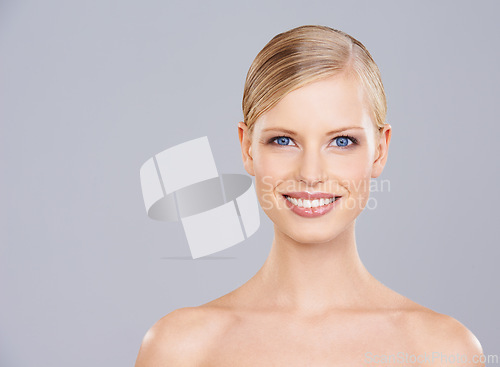 Image of Woman, face and smile for natural beauty, dermatology and wellness with cosmetic care on grey background. Facial, glow and portrait of happy model, headshot for clean skincare and shine in studio