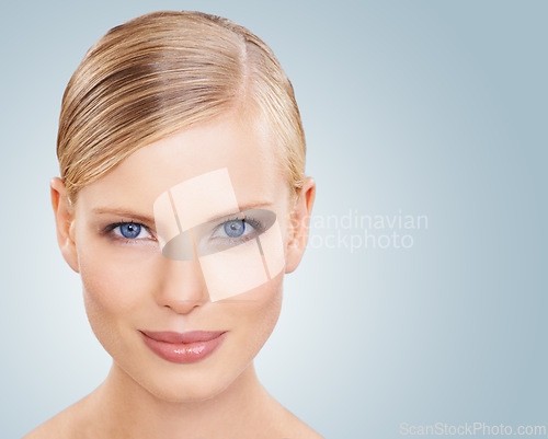 Image of Portrait, skincare and woman with cosmetics, wellness and beauty on a blue studio background. Face, person or model with shine and makeup with grooming or dermatology with aesthetic, mockup or facial
