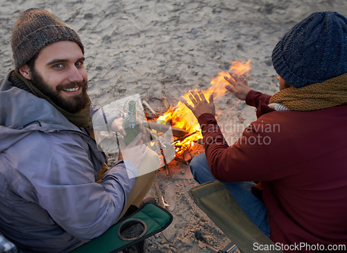 Image of Campfire, friends and portrait with men and beer by the beach at sunset with vacation and camping. Ocean, outdoor and together with travel and people with journey and fire with conversation by sea