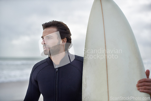 Image of Surfboard, waves and man on beach for surfing on vacation, holiday and weekend in ocean. Relax, thinking and person in wetsuit for water sports, hobby and exercise for adventure and freedom in sea