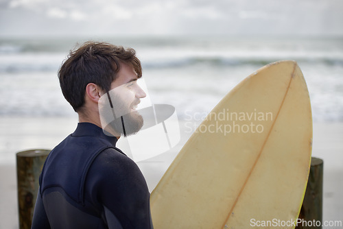 Image of Man, surfboard and exercise at beach on vacation, weekend and sports for fitness in water. Happy male person, hobby and island for ocean waves, wetsuit and traveling on holiday or getaway for peace