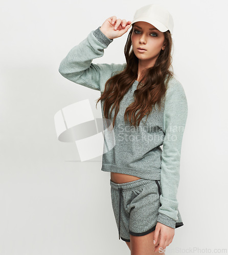 Image of Fashion, cap and woman portrait in studio with attitude, confidence and casual style on white background. Trendy, face and female model posing in cool, edgy or streetwear clothes or outfit choice