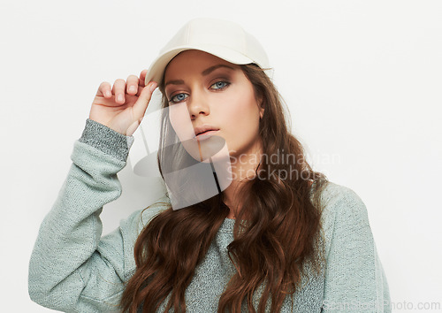 Image of Fashion, portrait and woman with a cap in studio with attitude, confidence or casual style on white background. Trendy, face and female model in cool, edgy or streetwear clothes or outfit choice