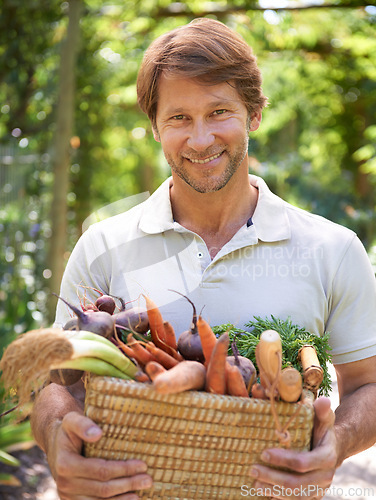 Image of Man, portrait and basket for vegetables harvest for small business or agriculture, production or sustainability. Male person, face and carrots or beetroot forr eco farming career, gardening or diet