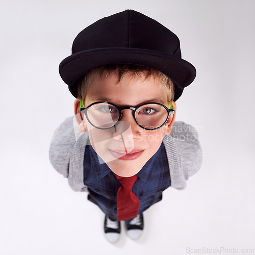 Image of Glasses, happy and portrait of child in studio for eye care, vision and optical health. Smile, optometry and top view of young boy kid with stylish eyewear or spectacles isolated by gray background.