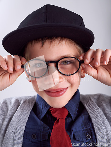 Image of Glasses, smile and portrait of child in studio for eye care, vision and optical health. Happy, optometry and cute young boy kid with stylish eyewear or spectacles isolated by gray background.