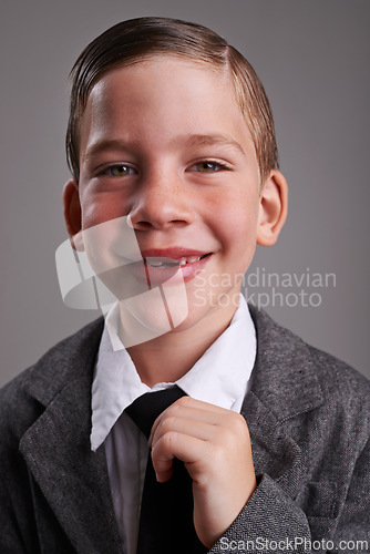 Image of Smile, fashion and portrait of child in studio with classy, fancy and trendy shirt and tie. Happy, cute and young boy kid with elegant style, confidence and positive attitude by gray background.