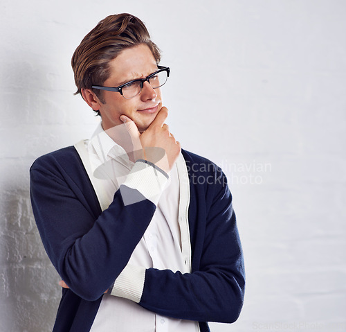 Image of Man, thinking and glasses for fashion and vision, eye care and future with designer frame on white background. Cosmetic, casual clothes with spectacles for insight and question with prescription lens